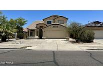 Charming two-story home featuring a tile roof, desert landscaping, and a two-car garage at 7817 S 46Th Dr, Laveen, AZ 85339