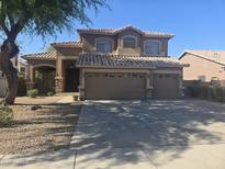 Charming two-story home featuring a three car garage, neutral colors, and tile roof at 955 W Laurel Ave, Gilbert, AZ 85233