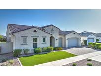 Charming single story home with manicured front yard, paver driveway, and classic Southwestern architecture at 10643 E Tumbleweed Ave, Mesa, AZ 85212