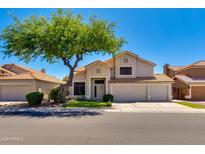 Charming two-story home with a well-manicured front yard and a mature shade tree at 18207 N 46Th St, Phoenix, AZ 85032