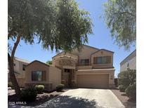 Charming two-story home featuring a stone accent wall, balcony, and a well-manicured front yard at 21280 N 96Th Ave, Peoria, AZ 85382