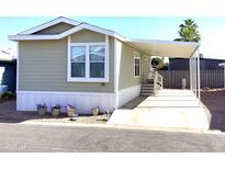 Inviting home featuring a covered carport and manicured flowerbeds at 2206 S Ellsworth Rd # 1736, Mesa, AZ 85209