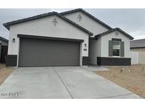 Charming single-Gathering home featuring a two-car garage and low maintenance desert landscaping at 24049 W Pima St, Buckeye, AZ 85326