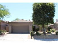 Charming single-story home with a tile roof, desert landscaping, and an attached two-car garage at 34464 N 68Th Way, Scottsdale, AZ 85266