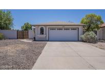 A cozy single-story home showing the garage, arched window and low maintenance landscaping at 3701 W Villa Maria Dr, Glendale, AZ 85308