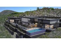 Stunning contemporary home featuring a backyard pool and elevated fire pit at 39307 N Silver Saddle Dr, Carefree, AZ 85377