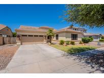 Charming single-story home featuring a well-manicured lawn, desert landscaping, and a spacious two-car garage at 4235 S Snowcap Dr, Gilbert, AZ 85297