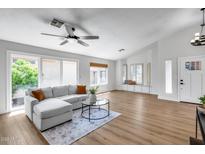 Bright living room with sliding glass doors and a comfortable gray sectional sofa with decorative pillows at 4344 W Kimberly Way, Glendale, AZ 85308