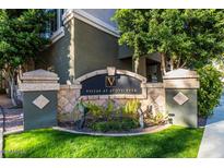 Stonecreek Villas sign framed by lush landscaping and greenery, giving a warm and inviting ambiance at 4465 E Paradise Village S Pkwy # 1200, Phoenix, AZ 85032