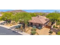 Attractive single-story home with desert landscaping, mature trees, and a tile roof in an upscale community at 7283 E Brisa Dr, Scottsdale, AZ 85266