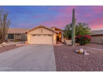 Charming single-Gathering home featuring a two-car garage, desert landscaping, and mature Saguaro cactus at 8061 E Lavender Dr, Gold Canyon, AZ 85118