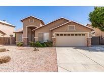 Charming single-story home featuring desert landscaping and a two-car garage at 8343 W Paradise Dr, Peoria, AZ 85345