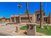 Charming single-story home with a two-car garage, lush landscaping, and Spanish-style tile roof at 10124 E Michigan Ave, Sun Lakes, AZ 85248