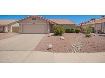 Charming single-story home with a well-maintained front yard, complemented by a two-car garage and a beautiful desert landscape at 11352 E Dartmouth St, Mesa, AZ 85207