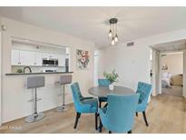 Inviting dining area with a modern pendant light, adjacent to the kitchen with bar stool seating at 154 W 5Th St # 246, Tempe, AZ 85281
