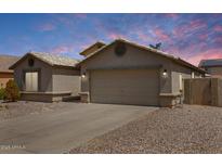 Charming single-story home featuring a two-car garage, desert landscaping, and a neutral color palette at 1564 E Leaf Rd, San Tan Valley, AZ 85140