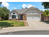 Charming single-Gathering home with a brick-accented facade, well-maintained lawn and two car garage at 18819 N 49Th Ave, Glendale, AZ 85308