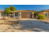 Charming single-story home featuring a tile roof, brown garage door, and low-maintenance landscaping at 20919 E Desert Hills Blvd, Queen Creek, AZ 85142
