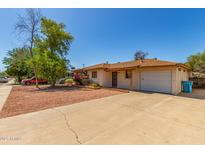Charming single-story home with gravel yard and mature trees under a clear blue sky at 2138 W Northview Ave, Phoenix, AZ 85021