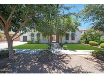 Charming single-story home featuring lush landscaping and a well-manicured lawn at 2859 E Los Altos Rd, Gilbert, AZ 85297