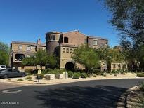 Attractive exterior view of a well-maintained multi-story condo building with desert landscaping and neutral colors at 3935 E Rough Rider Rd # 1282, Phoenix, AZ 85050