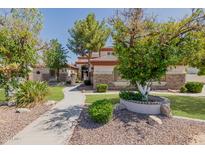 Beautiful single-Gathering home featuring a well-manicured lawn and mature trees in a desirable neighborhood at 3955 E Fox Cir, Mesa, AZ 85205