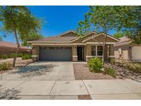Charming single-story home with a well-maintained lawn and a two-car garage at 4241 E Bonanza Rd, Gilbert, AZ 85297