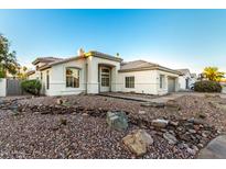 Charming single-story home with a well-manicured rock front yard and neutral color palette at 5426 E Karen Dr, Scottsdale, AZ 85254