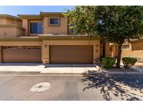 Charming townhome featuring a two-car garage and well-maintained landscaping at 705 W Queen Creek Rd # 2062, Chandler, AZ 85248