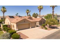 Charming beige home with a terracotta roof, two-car garage, and landscaped yard at 786 E Coconino Dr, Chandler, AZ 85249