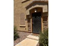Stylish front door with a decorative sunburst design and stone accents for added curb appeal at 1350 S Greenfield Rd # 1221, Mesa, AZ 85206