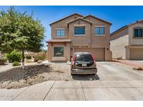 Two-story home featuring a two-car garage, neutral color scheme, and low maintenance desert landscaping at 15006 N 172Nd Ln, Surprise, AZ 85388