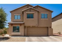 Charming two-story home with a well-maintained front yard and a spacious two-car garage at 15006 N 172Nd Ln, Surprise, AZ 85388
