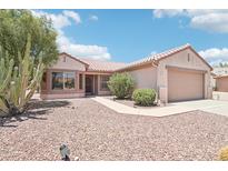 Charming single-story home features a well-kept landscape, desert flora, and a two-car garage at 20234 N Mariposa Way, Surprise, AZ 85374