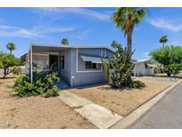 Charming single-story home with desert landscaping, including mature cactus and palm trees at 2650 W Union Hills Dr # 215, Phoenix, AZ 85027