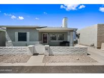Charming single-story home featuring a cozy front porch and well-maintained desert landscaping at 2929 E Broadway Rd # 50, Mesa, AZ 85204