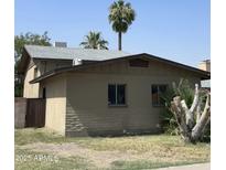 A view of the house, landscaping, and surrounding greenery at 4316 W Rose Ln, Glendale, AZ 85301
