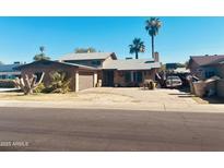 Charming single-Gathering home featuring desert landscaping, a two-car garage, and a classic architectural style at 4316 W Rose Ln, Glendale, AZ 85301