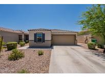 Charming single-story home featuring a well-maintained front yard and two-car garage at 7238 N 126Th Ln, Glendale, AZ 85307