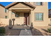 Inviting front porch with stylish supports and desert landscaping at 909 E Agua Fria Ln, Avondale, AZ 85323