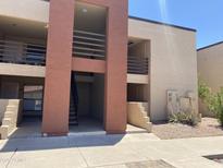 A clean, multi-level exterior view of the apartment complex featuring pedestrian access and well-maintained landscaping at 1340 N Recker Rd # 154, Mesa, AZ 85205