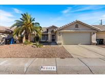 Charming single-story home with a two car garage and a desert-landscaped front yard at 1415 W Michigan Ave, Phoenix, AZ 85023