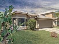 Charming single-story home with well-maintained lawn, desert landscaping, and an attached two-car garage at 45726 W Long Way, Maricopa, AZ 85139