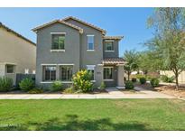 Charming two-story home with a well-manicured lawn and desert landscaping for curb appeal at 4712 E Bonanza Rd, Gilbert, AZ 85297
