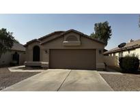 Charming single-story home featuring desert landscaping and a two-car garage with a neutral color scheme at 515 E Sherri Dr, Gilbert, AZ 85296