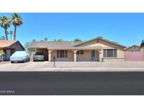 Charming single-story home featuring a covered front porch and desert landscaping at 5800 S College Ave, Tempe, AZ 85283