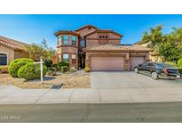 Charming two-story home with a three-car garage, tile roof, and well-manicured landscaping at 7246 W Monte Cristo Ave, Peoria, AZ 85382