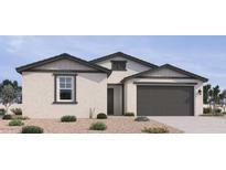 Charming single-story home with neutral stucco, complemented by grey accents and a two-car garage at 15731 W Brown St, Waddell, AZ 85355