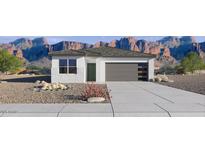 Charming single-story home featuring a neutral color palette, a gray roof, and a two-car garage at 18346 W Hackamore Dr, Wittmann, AZ 85361