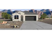 Charming single-story home featuring desert landscaping and a two-car garage, set against a backdrop of striking mountains at 18354 W Hackamore Dr, Wittmann, AZ 85361